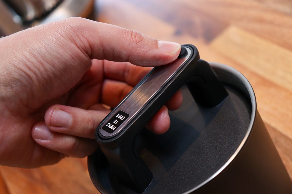 Close-up of the adjustable canister lid and its release button