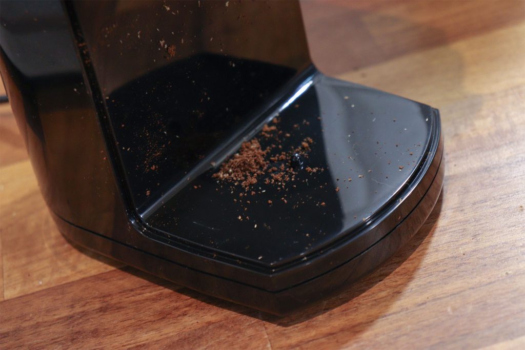 Coffee grounds left on the grinder platform after use